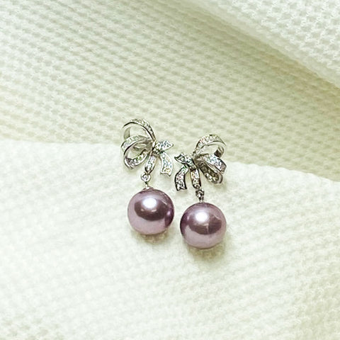 Caroline Half Bow Purple Pearl Earrings | Earrings | 925 sterling silver, cultured pearl earrings, cultured pearls, dangle earrings, drop earrings, earrings, Fine Jewelry, fresh water pearl earring, fresh water pearls, half bow pearl earrings, intricate design earring, metallic pearl, metallic pearl earrings, new arrivals, pearl earrings, purple pearl earrings, S925 earrings, silvery pearls, sterling silver earring, unique pearl | Dikuza