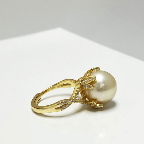Audrey South Sea Gold Pearl Ring Sitting in a Golden Crown | Rings | 14k gold plated pearl ring, adjustable ring, cultured pearls, Fine Jewelry, flower shaped ring, gold pearl ring, gold plated pearl ring, gold ring, new arrivals, pearl ring, rings, S925 gold plated ring, south sea pearl, South Sea Pearl Pavé Ring, South Sea Pearl Ring Sitting in a Golden Crown, unique pearl, white pearls, zircon ring | Dikuza