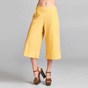 A model showcasing Linen Wide Leg Culottes with pockets in a neutral setting